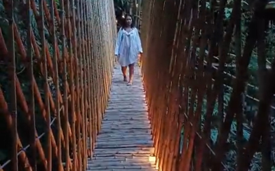 Olivia walking the bamboo bridge across Ayung river.